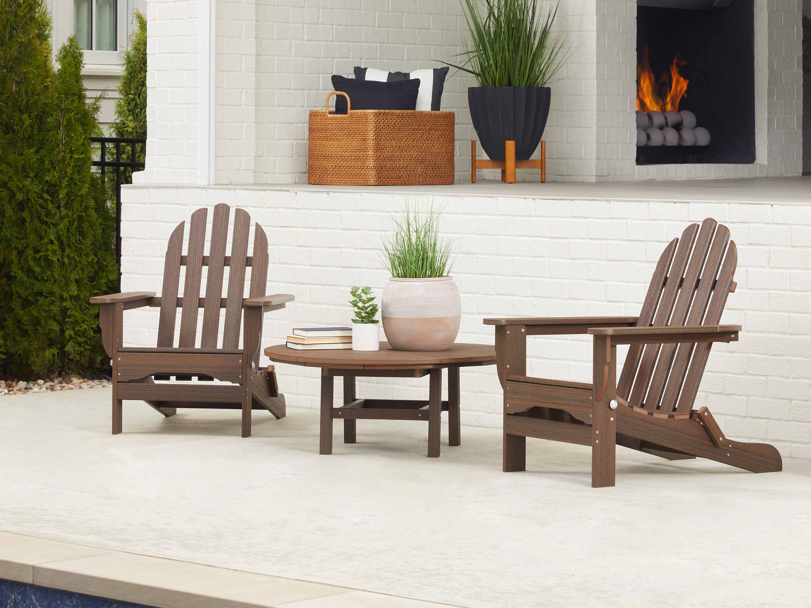 Two Folding Adirondack Chairs with Madison Conversation Table on Patio with Plants