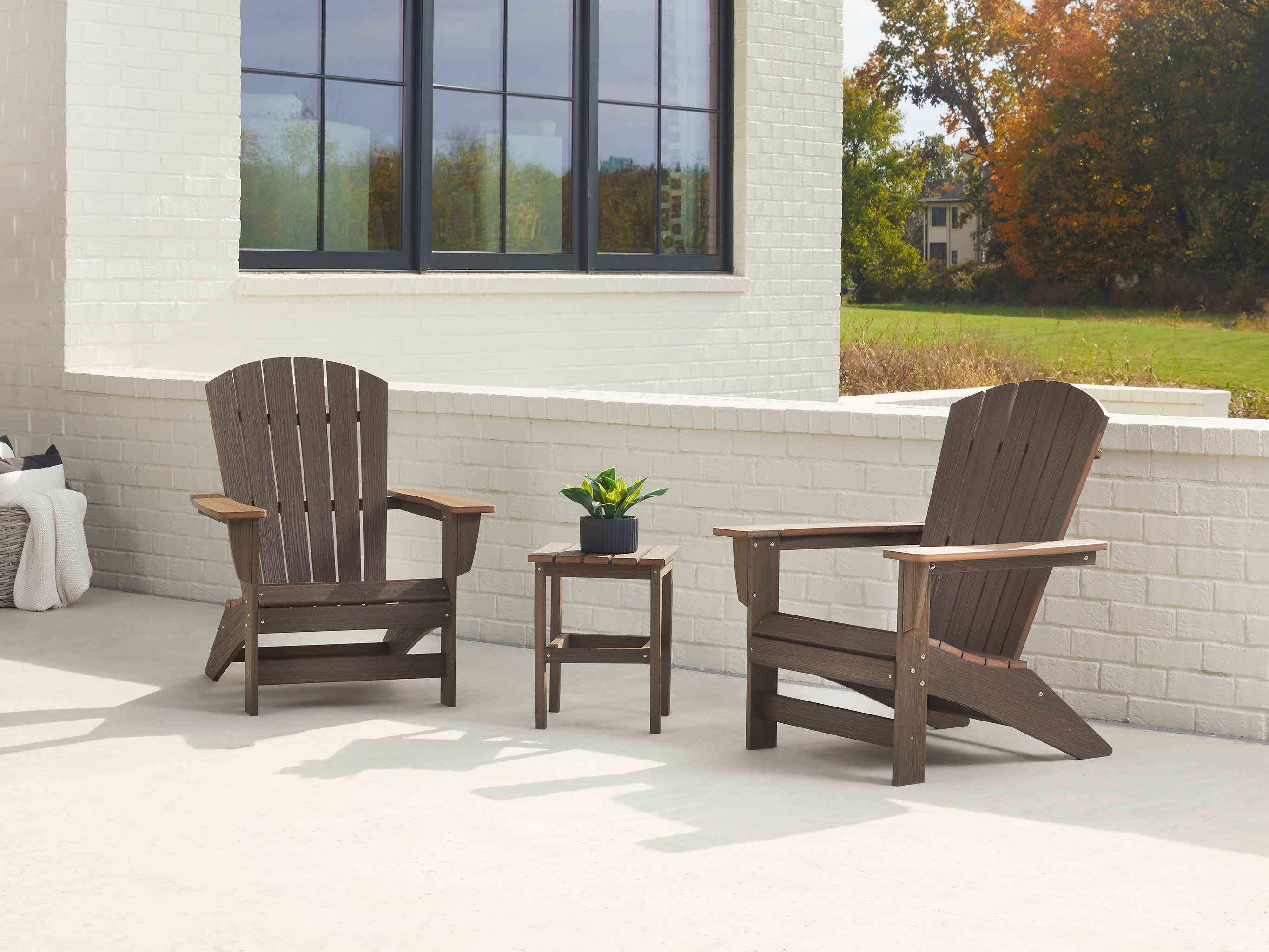Brazilian Walnut Johnson Bay Adirondack Chair set with Side table on white brick patio